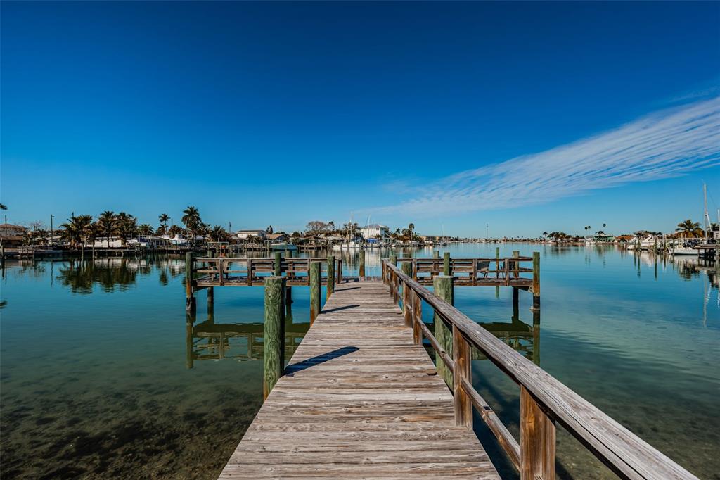 713 Pruitt Drive Madeira Beach, FL 33708 - Photo 57 of 62 a view of a lake with boats and trees in the background