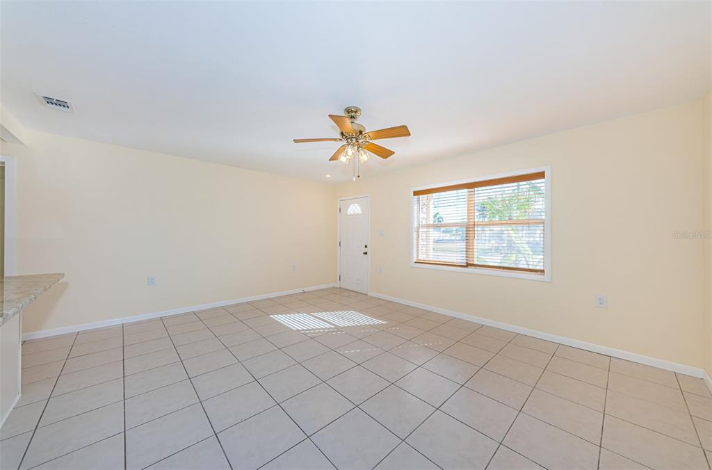 713 Pruitt Drive Madeira Beach, FL 33708 - Photo 8 of 62 an empty room with windows and ceiling fan