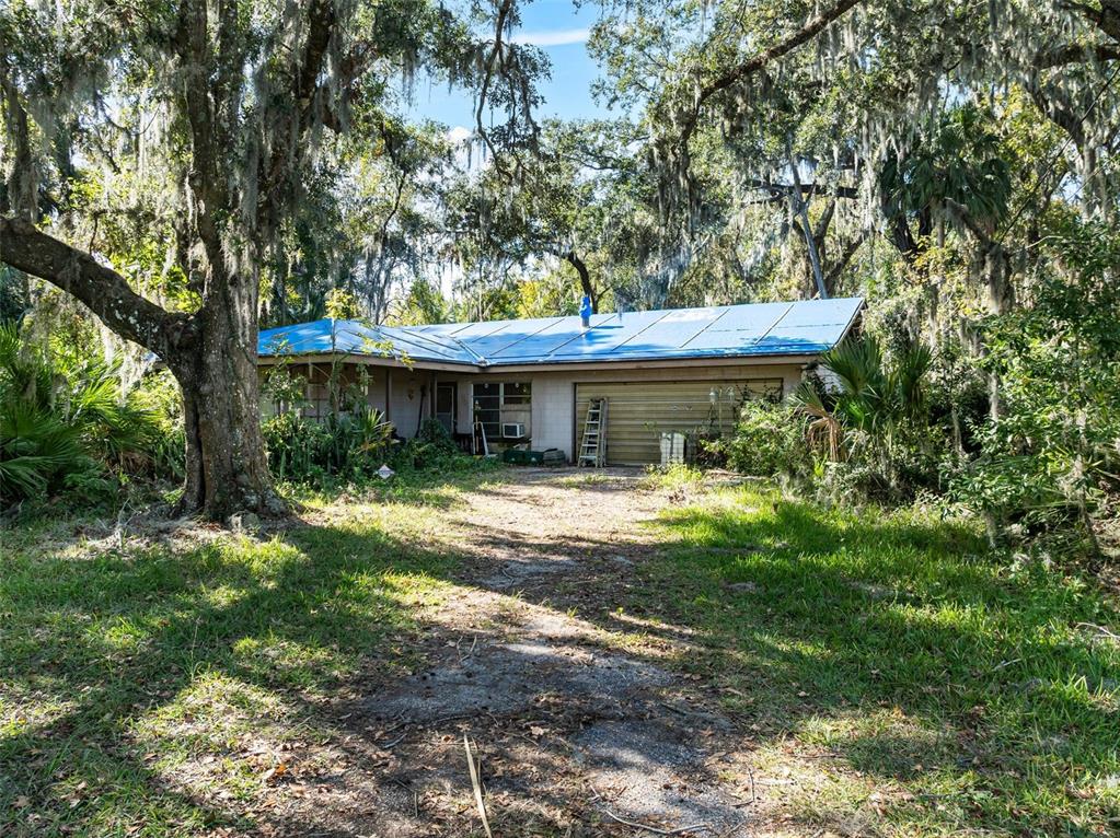 420 Monroe Road Sanford, FL 32771 - Photo 1 of 28 a front view of a house with a yard table and chairs