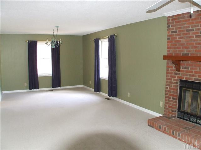 5520 Middleton Road Durham, NC 27713 - Photo 7 of 10 a view of an empty room with a fireplace and a window