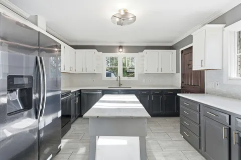 a kitchen with a refrigerator a sink and a stove