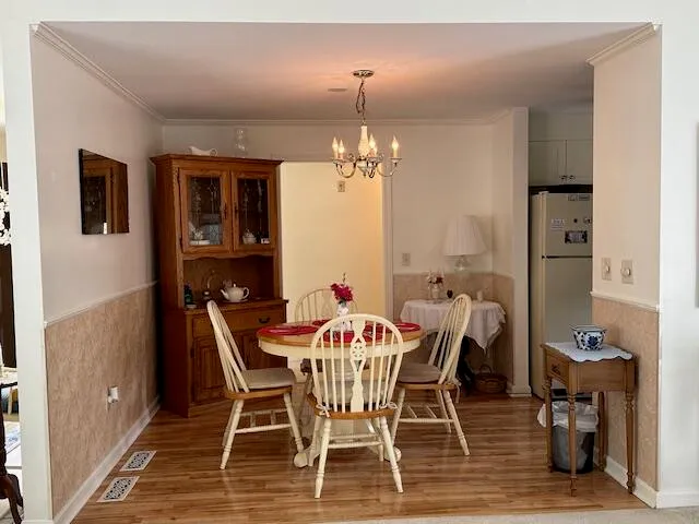 a view of a dining room with furniture and chandelier