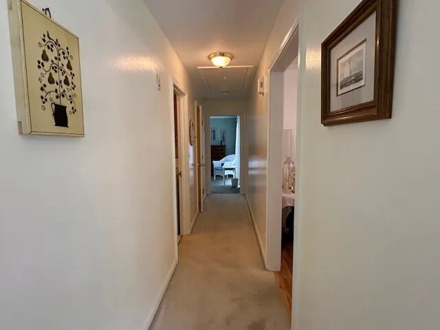 a view of a hallway with paintings on the wall