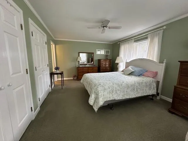 a bedroom with a bed chandelier and window