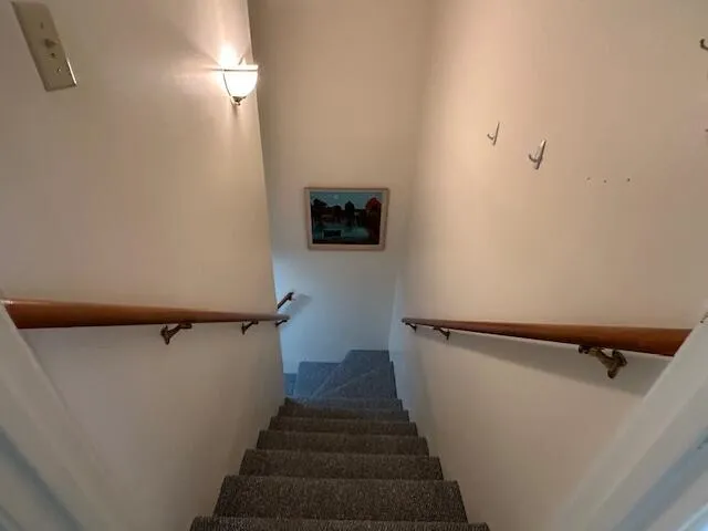 a view of a hallway with stairs