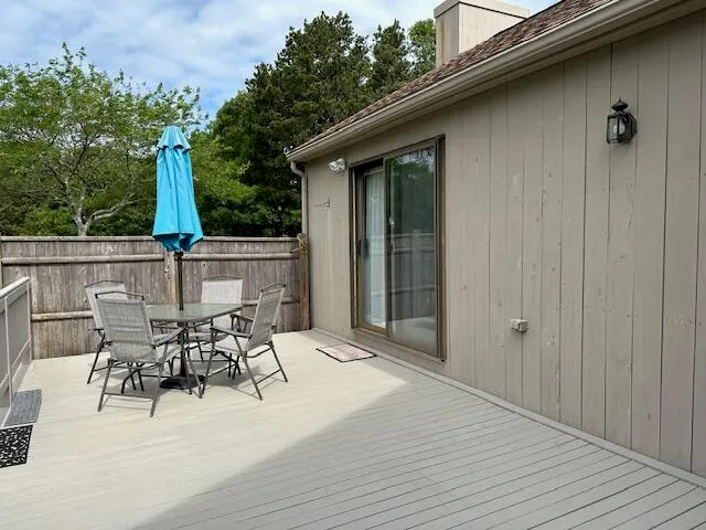 a view of a deck with wooden floor and fence