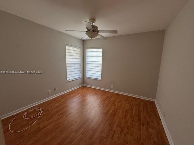 9317 Arborwood Circle Davie, FL 33328 - Photo 17 of 24 an empty room with wooden floor chandelier fan and windows