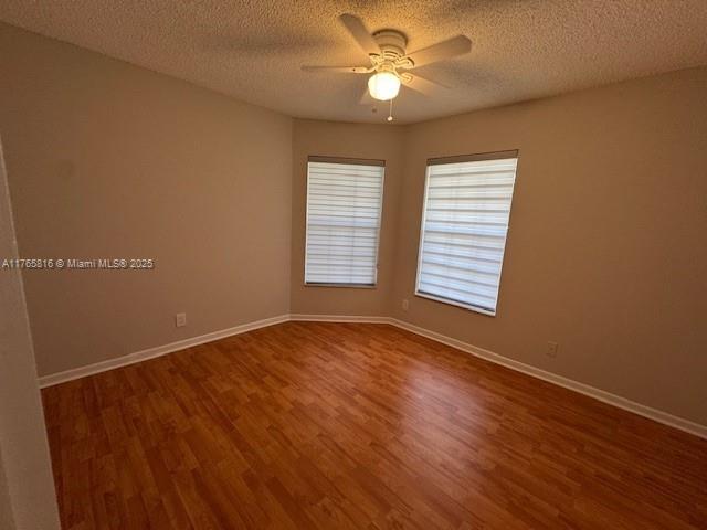 9317 Arborwood Circle Davie, FL 33328 - Photo 18 of 24 a view of an empty room with a window and wooden floor