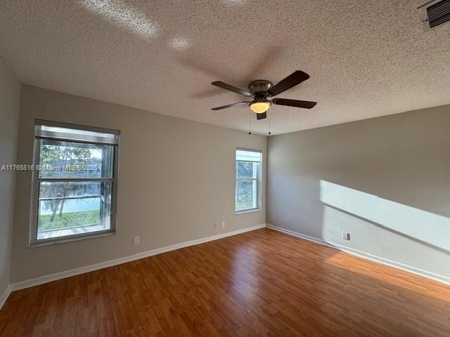 9317 Arborwood Circle Davie, FL 33328 - Photo 19 of 24 an empty room with wooden floor and windows