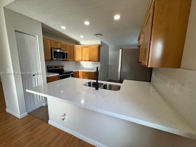 9317 Arborwood Circle Davie, FL 33328 - Photo 5 of 24 a large white kitchen with stainless steel appliances a refrigerator and a sink
