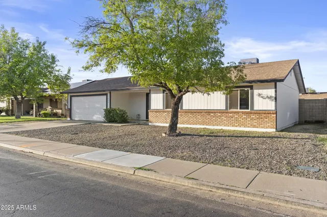 a view of a house with swimming pool and sitting area