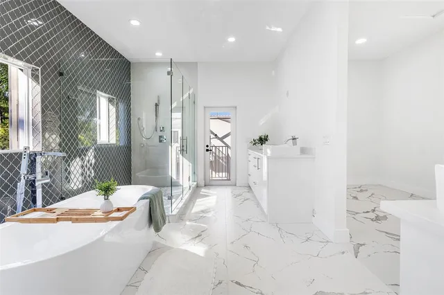 a spacious bathroom with a tub sink and shower