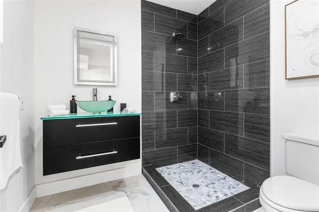 a bedroom with a bed and a painting on wall