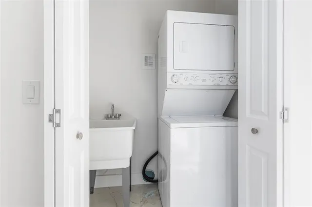 a front view of a house with swimming pool and a patio