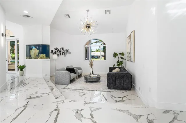 a bedroom with furniture a chandelier and a window