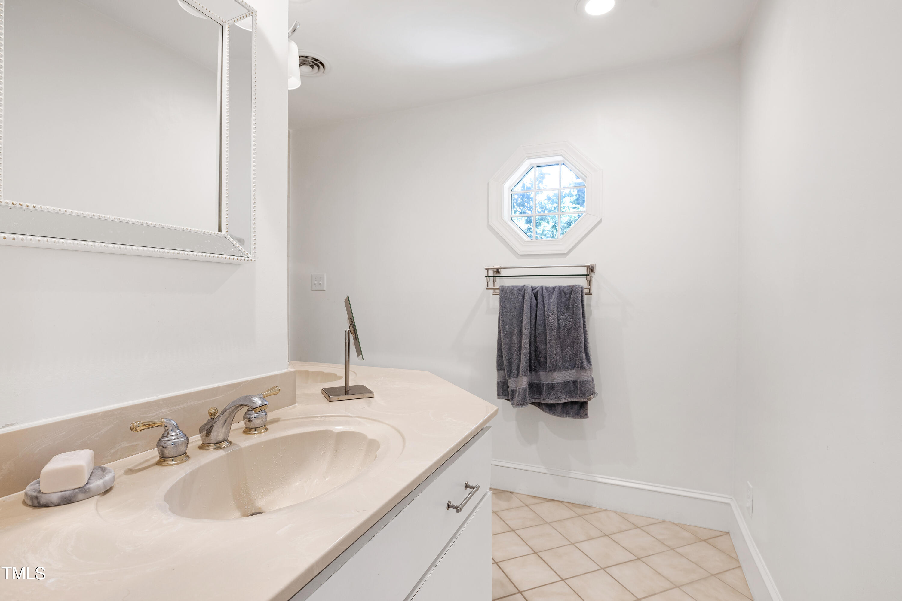 112 Queensferry Road Cary, NC 27511 - Photo 20 of 41 a bathroom with a sink a vanity and a mirror