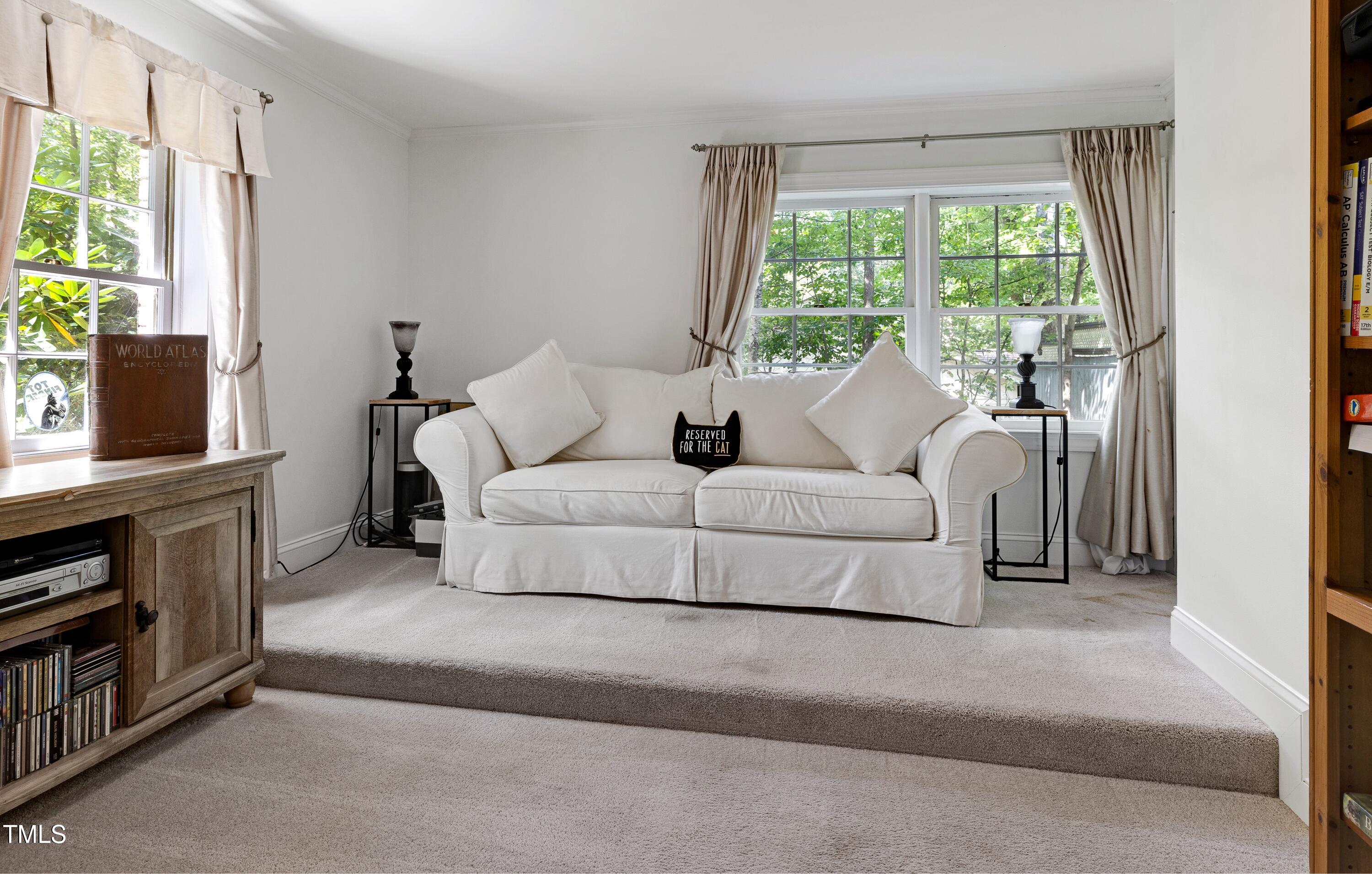 112 Queensferry Road Cary, NC 27511 - Photo 30 of 41 a living room with furniture and a flat screen tv
