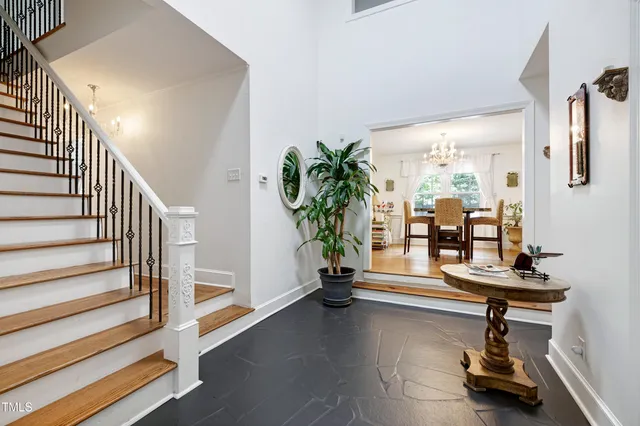 a kitchen with stainless steel appliances white cabinets and a wooden floor