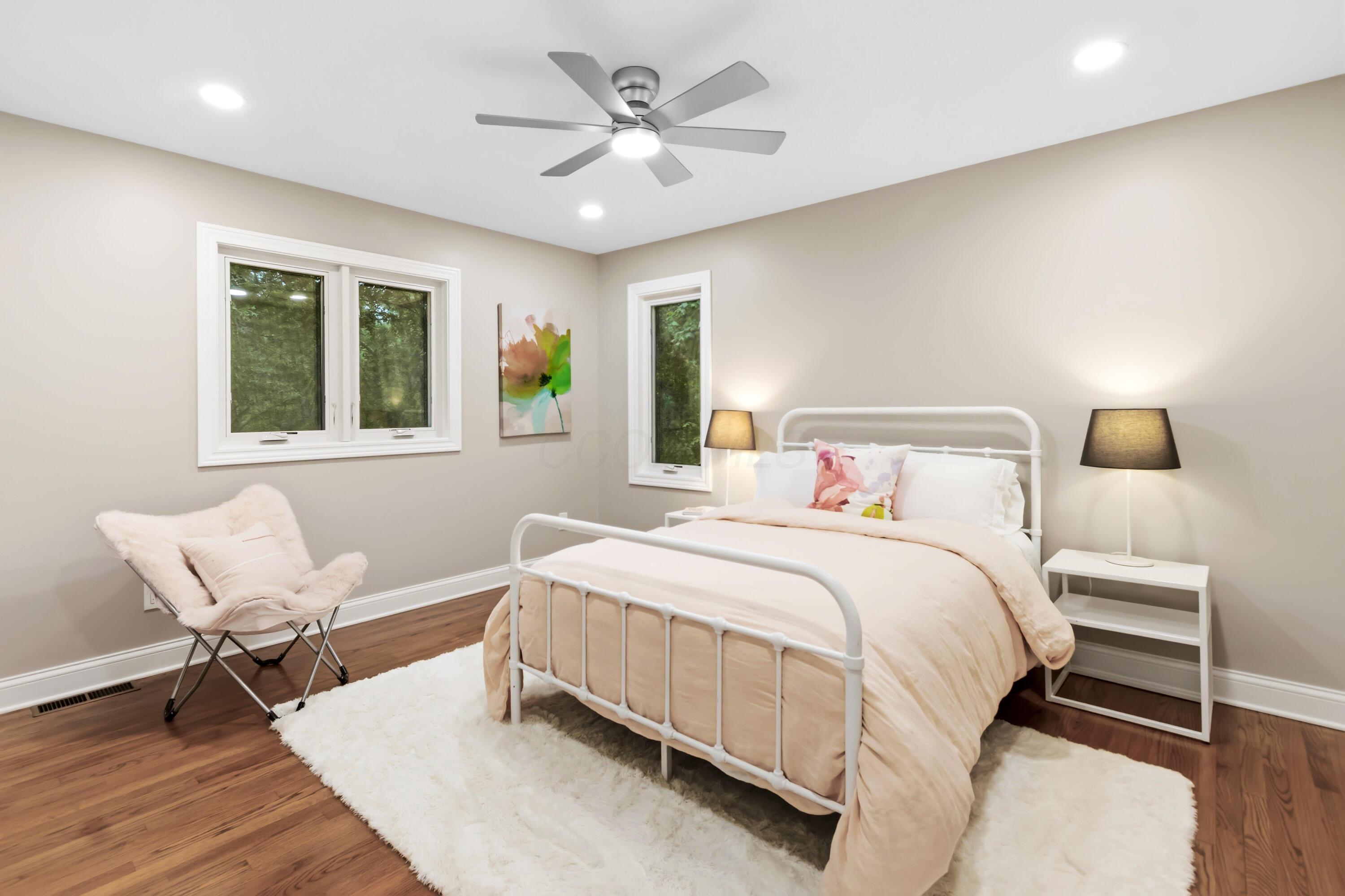 1560 Carriage Road Powell, OH 43065 - Photo 42 of 73 Recessed ceiling lighting, a five-blade ceiling fan with integrated light, wood flooring, and white trim throughout