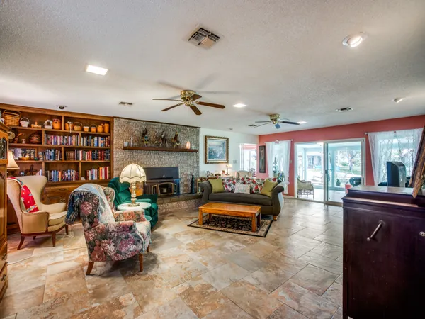 a living room with furniture gym equipment and a fireplace