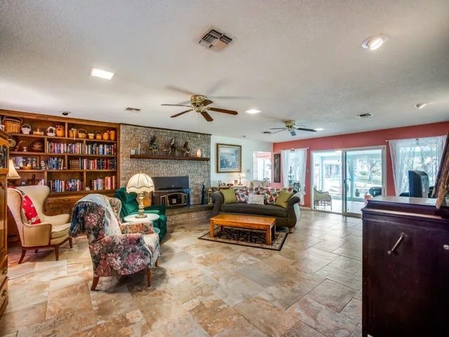 a living room with furniture gym equipment and a fireplace