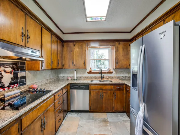 a kitchen with a sink stove and cabinets