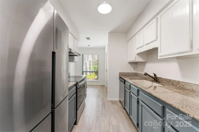 a kitchen with a sink stove and refrigerator