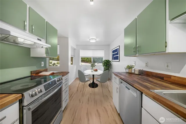 a dining room with furniture and a kitchen view
