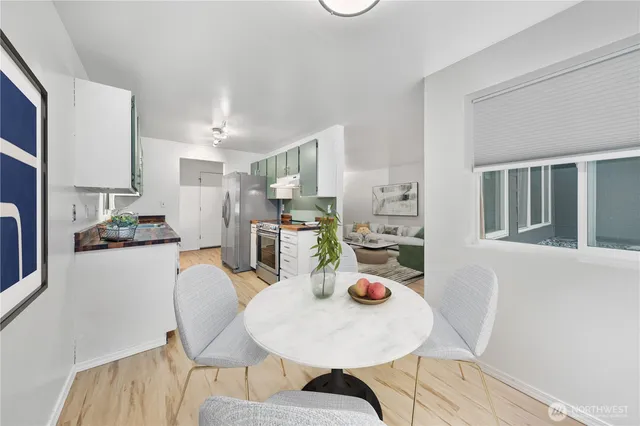 a living room with furniture potted plant and a table