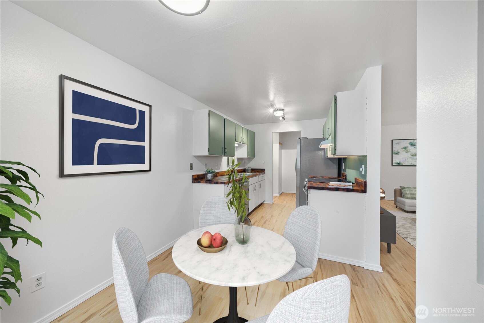7021 Sand Point Way Northeast, Unit B201 Seattle, WA 98115 - Photo 8 of 29 a living room with furniture potted plant and a table