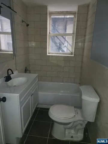 a bathroom with a toilet sink and bathtub