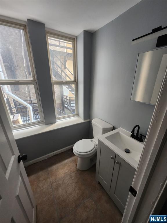 316 South Orange Avenue, Unit BS Newark, NJ 07103 - Photo 7 of 7 a bathroom with a sink a toilet and a window