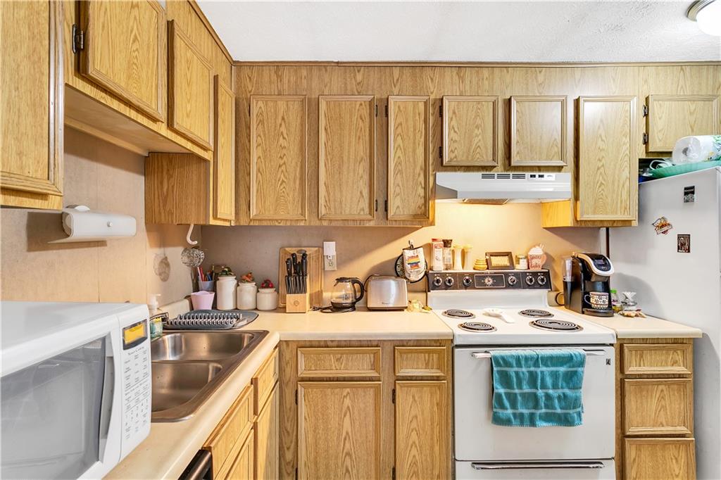 241 Coxcomb Hill Road, Unit 30 New Kensington, PA 15068 - Photo 7 of 16 a kitchen with a sink stove and cabinets