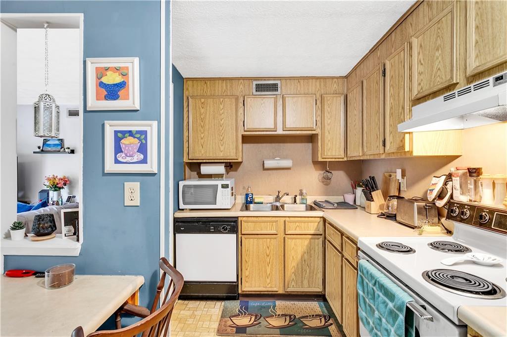 241 Coxcomb Hill Road, Unit 30 New Kensington, PA 15068 - Photo 8 of 16 a kitchen with stainless steel appliances a sink a stove a refrigerator cabinets and a window