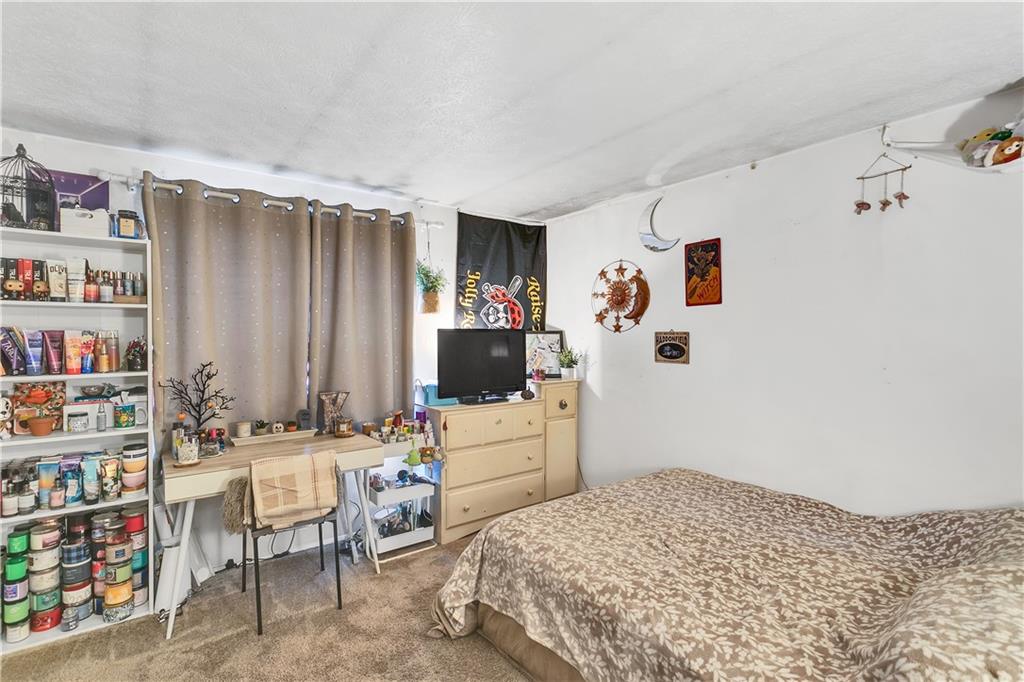 241 Coxcomb Hill Road, Unit 30 New Kensington, PA 15068 - Photo 10 of 16 a bedroom with a bed and a book shelf