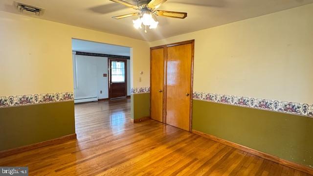 4202 Black Rock Road Hampstead, MD 21074 - Photo 10 of 30 a view of a room with wooden floor a ceiling fan and windows