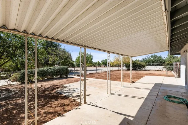a patio with yard glass top table and chairs