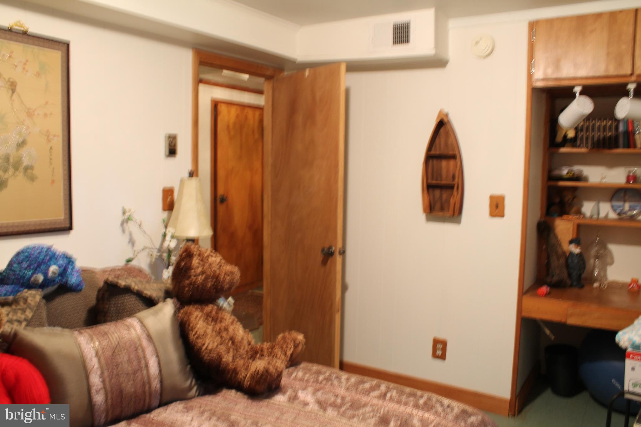 306 Liberty Road Reedville, VA 22539 - Photo 35 of 43 bedroom has built in desk with book shelves