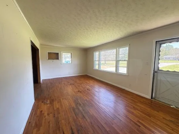 a view of a field with trees in the background