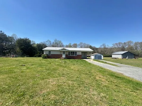 a kitchen with stainless steel appliances granite countertop a sink stove and wooden floor