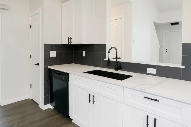 a kitchen with a sink and cabinets