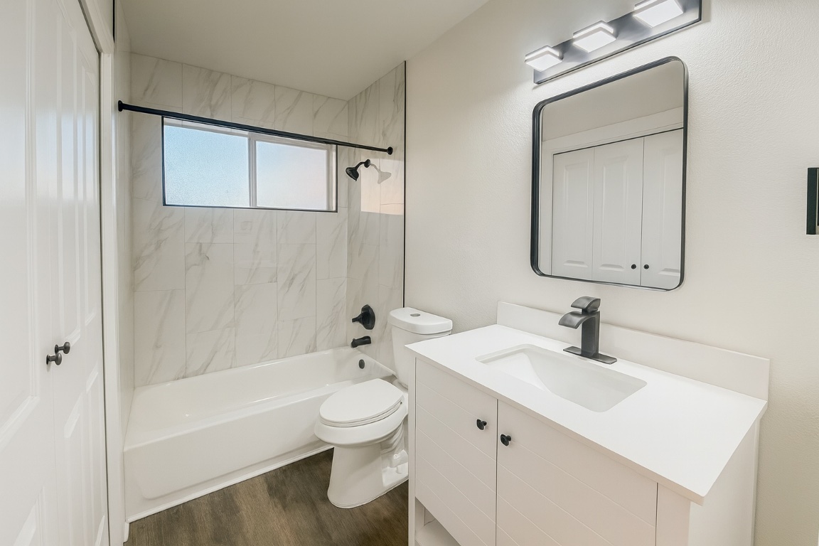 1015 East Yager Lane, Unit 51 Austin, TX 78753 - Photo 6 of 11 a bathroom with a sink toilet and shower
