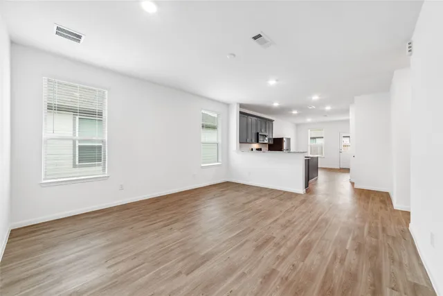 a view of a kitchen with a sink and a refrigerator