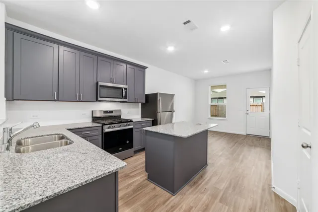 a kitchen with sink cabinets and microwave