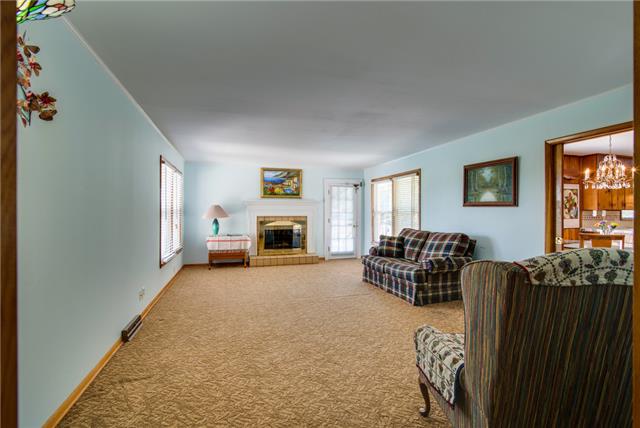 732 Baker Road Smyrna, TN 37167 - Photo 11 of 20 Large family area with wood burning fireplace and a view of the beautiful in-ground pool.
