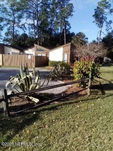 a view of a backyard with sitting area