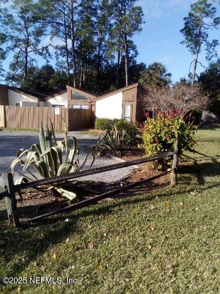 a view of a backyard with sitting area