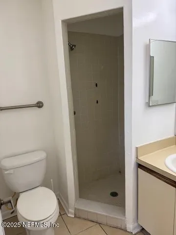 a white toilet sitting next to a bathroom sink