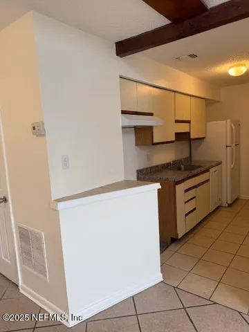 a kitchen with stainless steel appliances granite countertop a refrigerator sink and stove