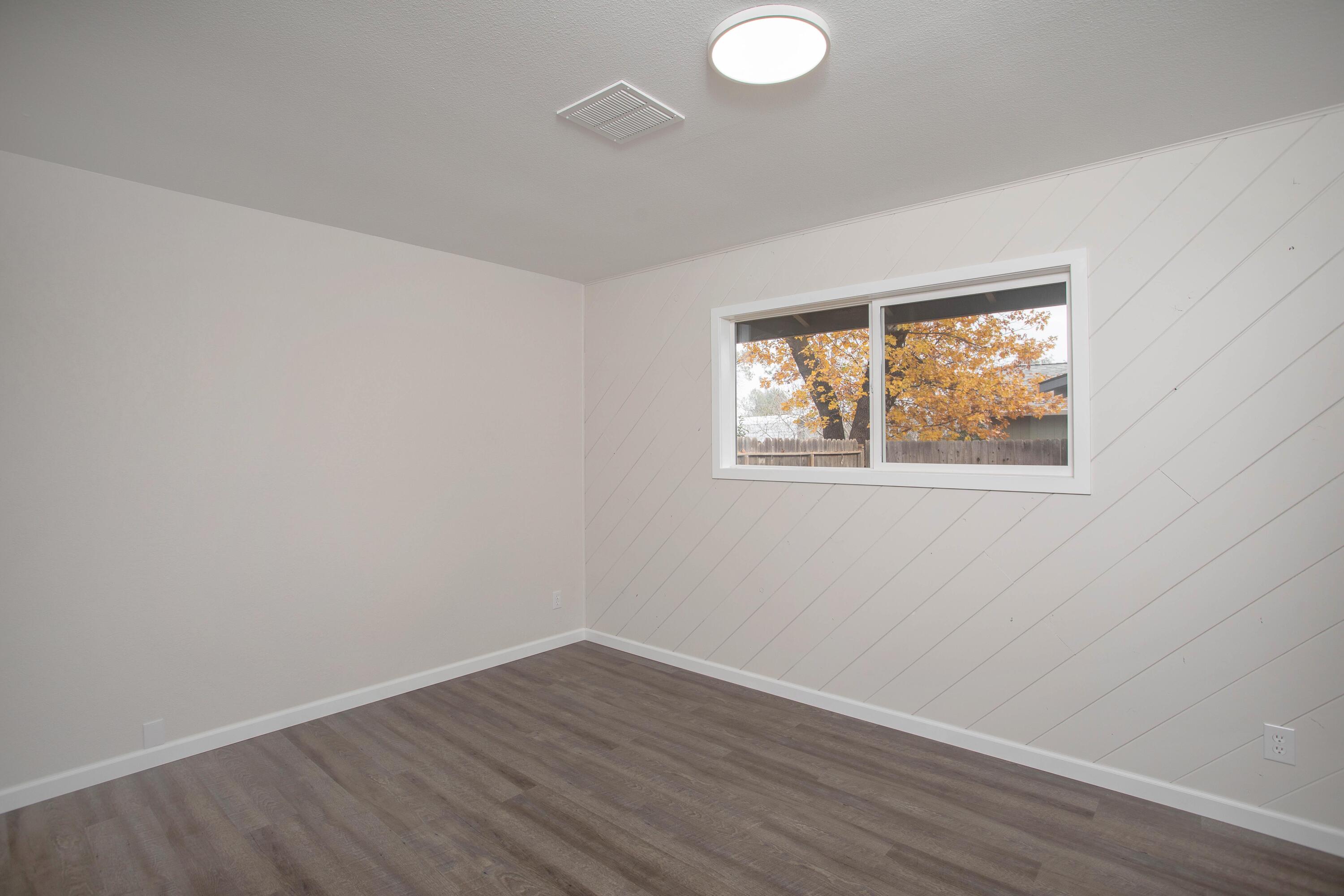 3693 Echo Road Redding, CA 96002 - Photo 17 of 30 a view of an empty room with wooden floor and a window